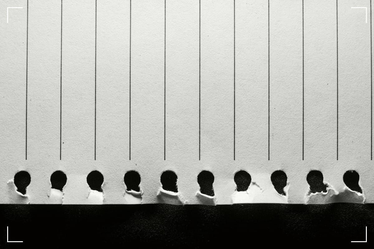 Lined paper with ripped holes.