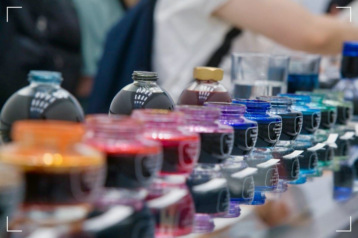 Fountain pen ink bottles lined upfrom the left to the right.