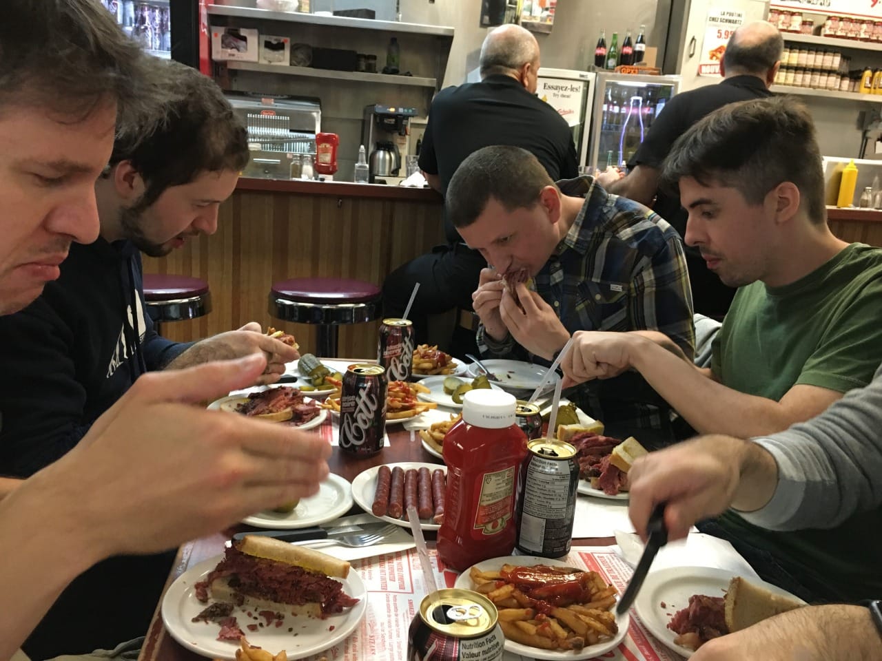 The team enjoys smoked meat sandwiches