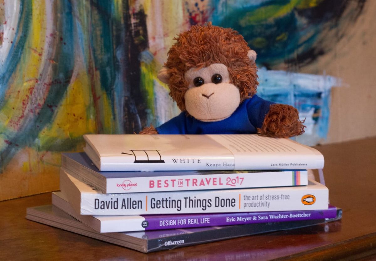 Bob T. Monkey with a stack of books