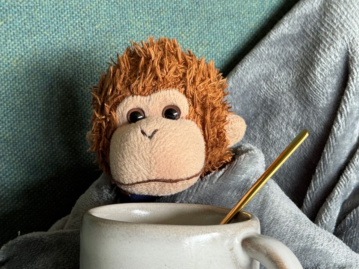 Bob relaxing with a tea and a heating pad.