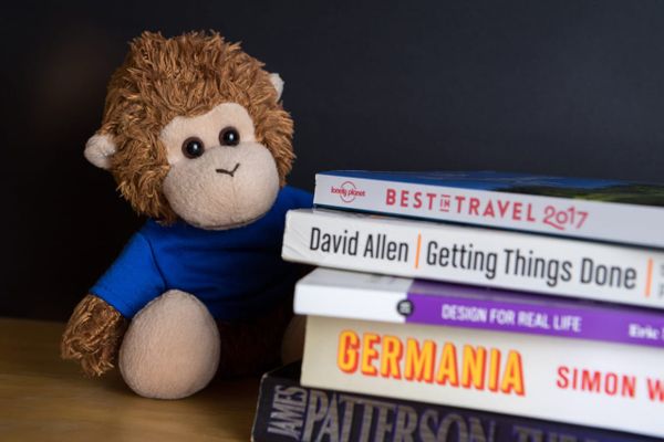 Bob T. Monkey reviews a stack of books