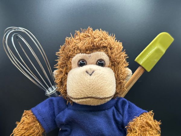 Bob T. Monkey with a spatula and whisk.
