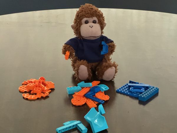 Bob T. Monkey sorting out different colored LEGO bricks.