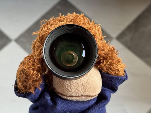 Bob holding a lens to his eye to get a narrow focus.