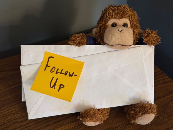 Bob holding a giant stack of envelopes labeled "Follow-up".