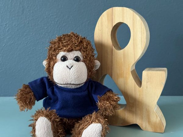 Bob sitting in front of a wooden ampersand, contemplating all the possible combinations.