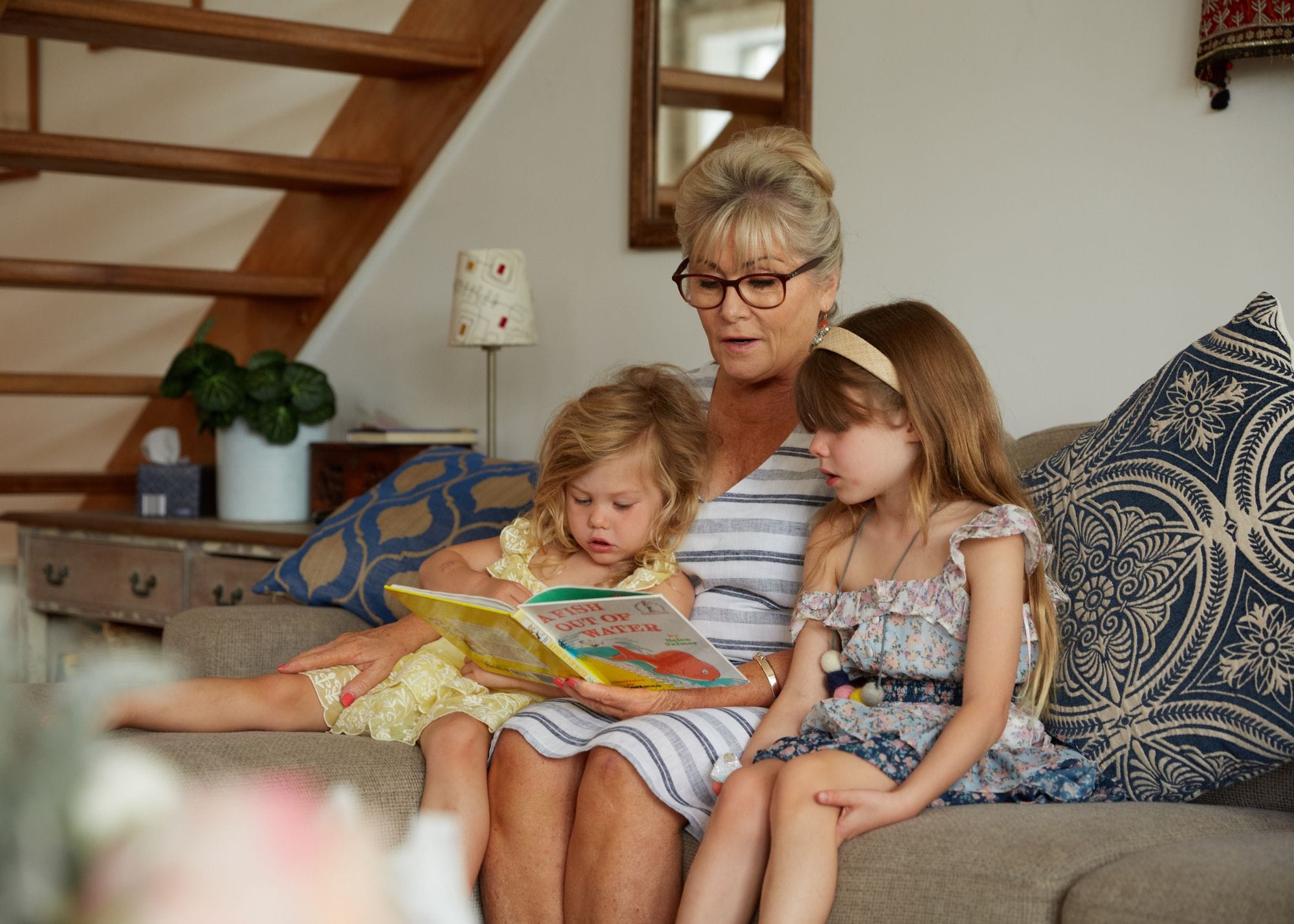 nanny reading a book to children.jpg