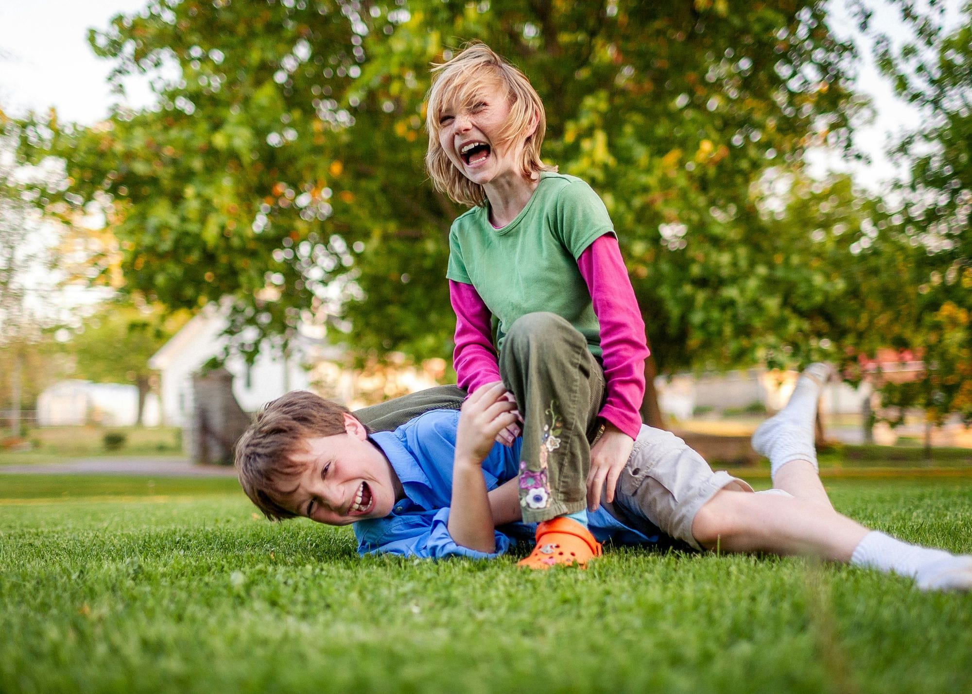 Two children playing on grass.jpg