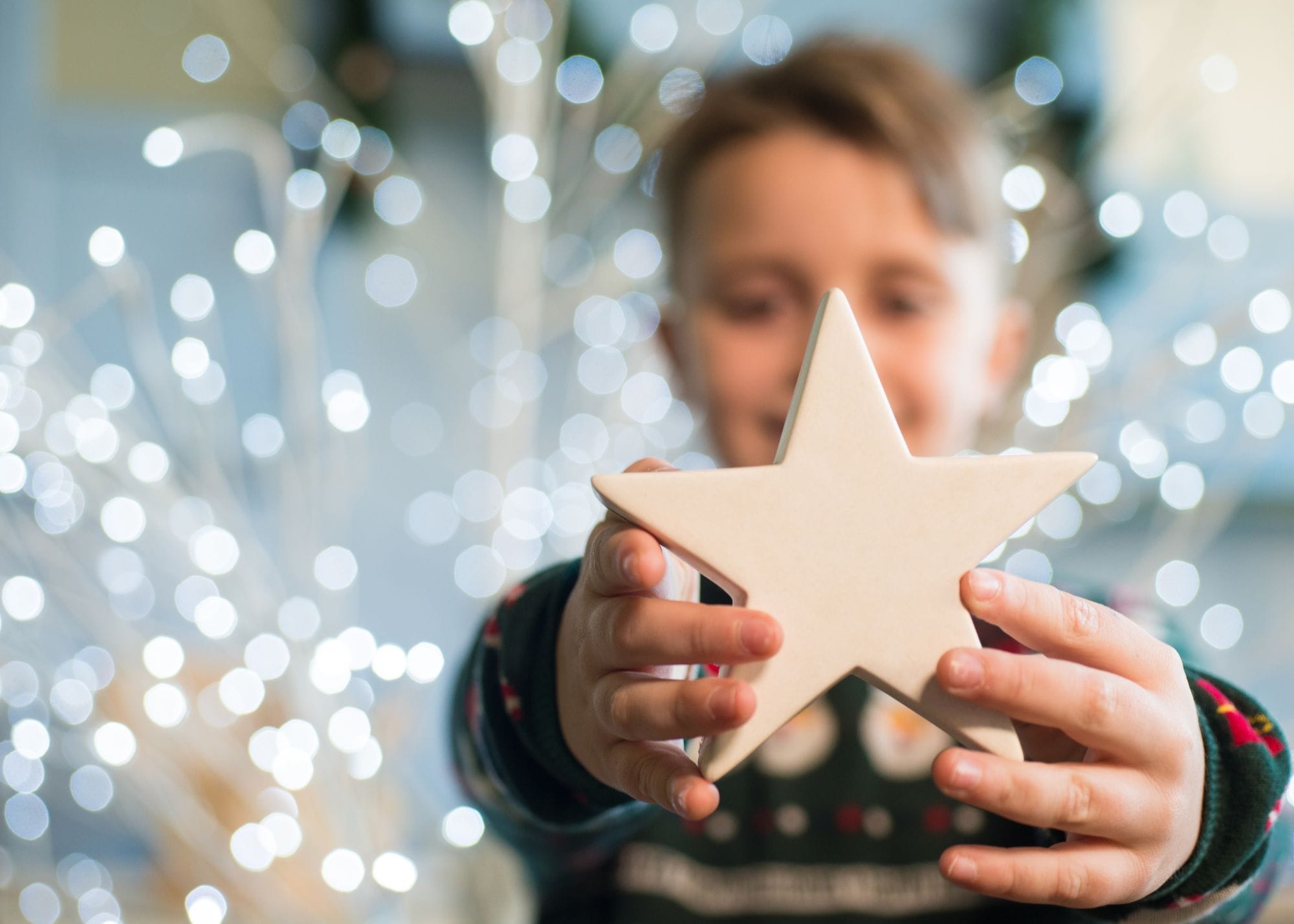 Little boy holding a star smiling.jpg