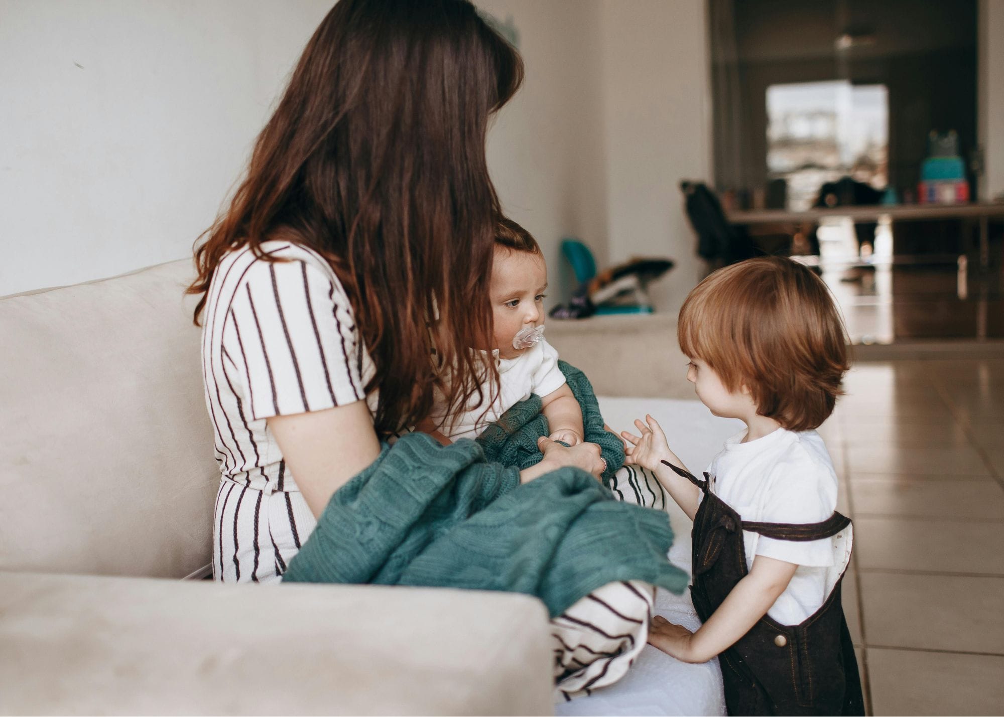 Juggle St nanny holding a baby with a toddler