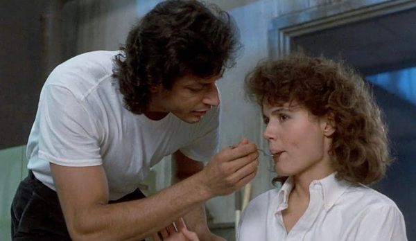 Seth Brundle (Jeff Goldblum) gives Ronnie Quaife (Geena Davis) a bite of teleported steak. From David Cronenberg’s The Fly (1986).