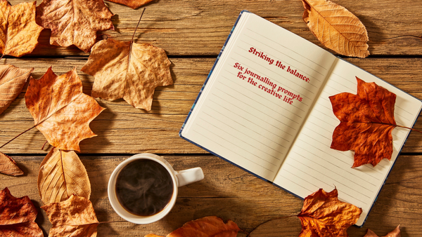 Open notebook beside a cup of coffee and autumn leaves, with the words “Striking the balance. Six journalling prompts for the creative life”, illustrating creative reflection and journalling 