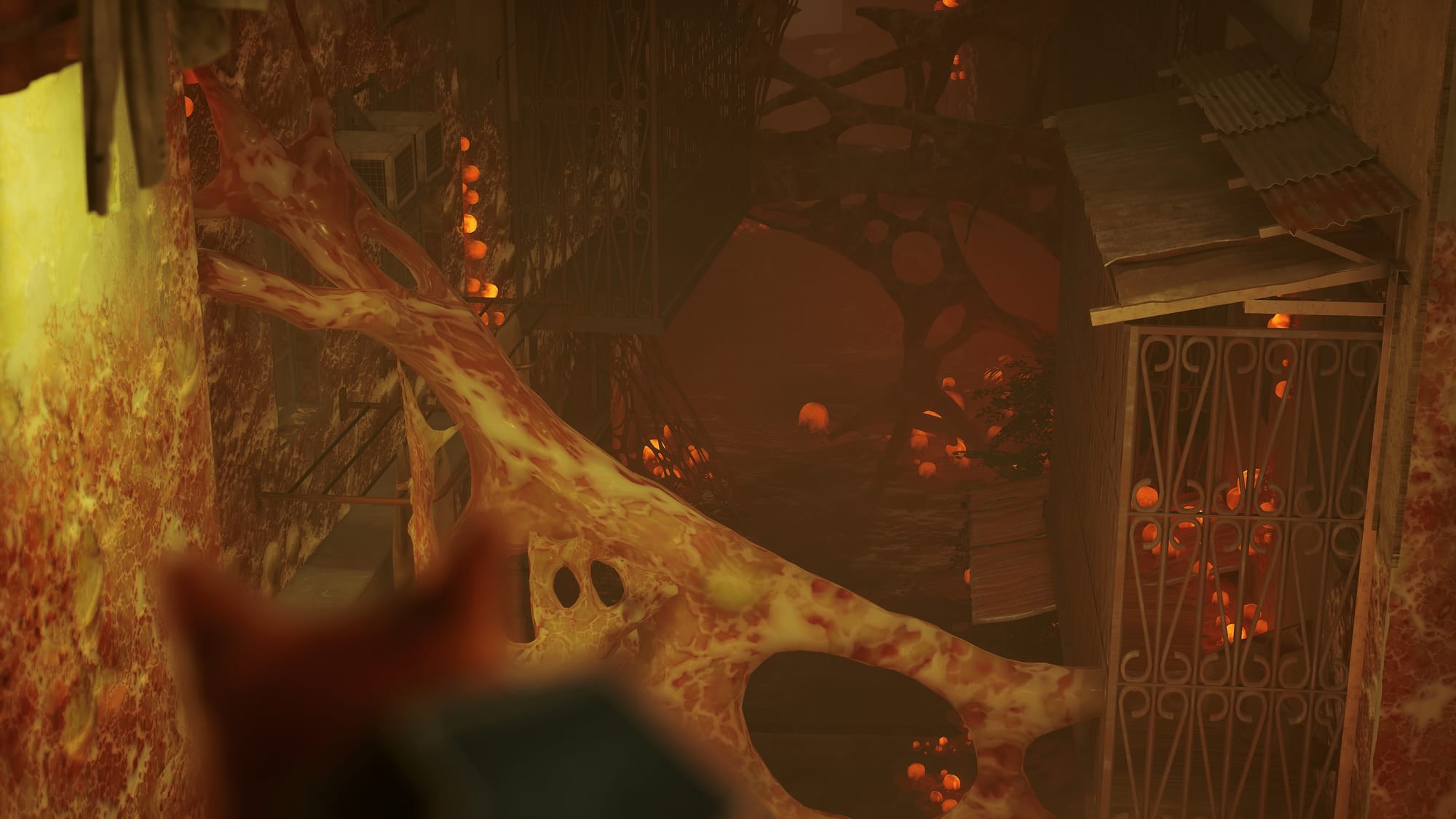 View of a dark alley infested with fleshy strands of mucus. Patched of egg sacks glow orange.