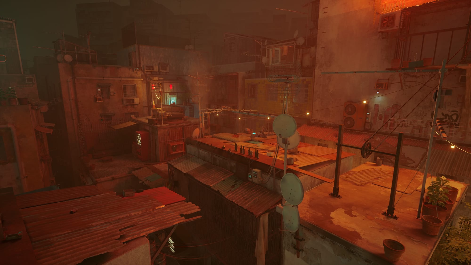 View of the rooftops of tightly packed, dilapidated buildings illuminated by a rusty orange light.