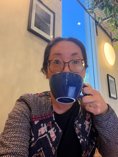 Clara drinking a latte