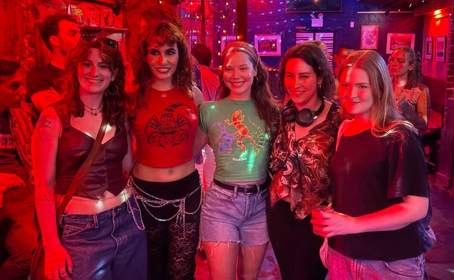 Lexee and her friends after one of her shows, she is wearing her own merch - a one of a kind red tank top with the scorpion print