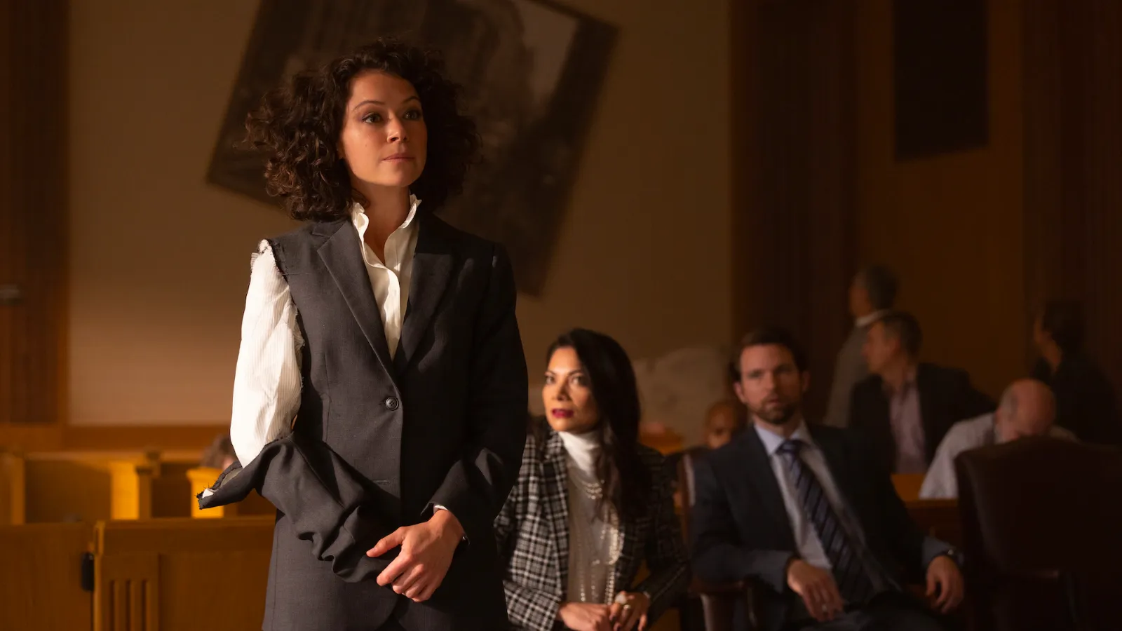 Tatiana Maslany, wearing a slightly shredded suit, does legal stuff in SHE-HULK: ATTORNEY AT LAW.