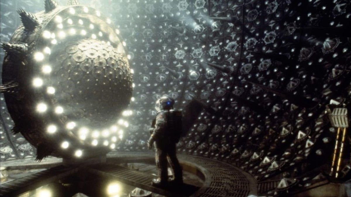 An astronaut gets much too close to a ball of pure evil surrounded by pulsating lights in EVENT HORIZON. Idiot.