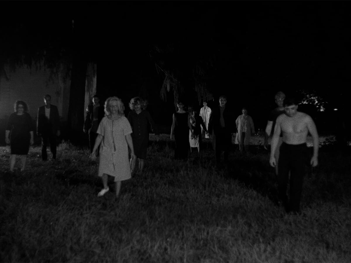 Shambling ghouls approach the camera in a still from NIGHT OF THE LIVING DEAD.