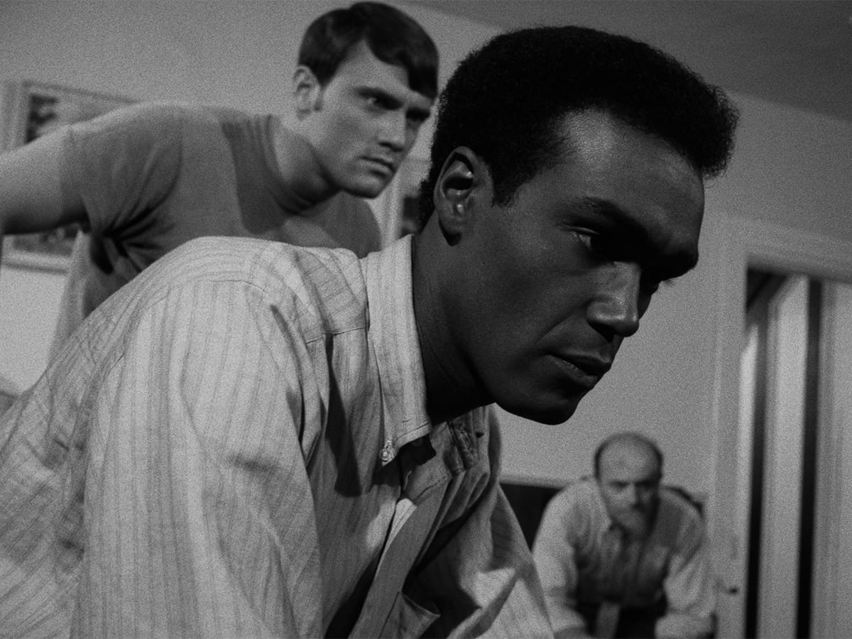 Flanked by Keith Wayne and Karl Hardman, Duane Jones watches television in NIGHT OF THE LIVING DEAD.