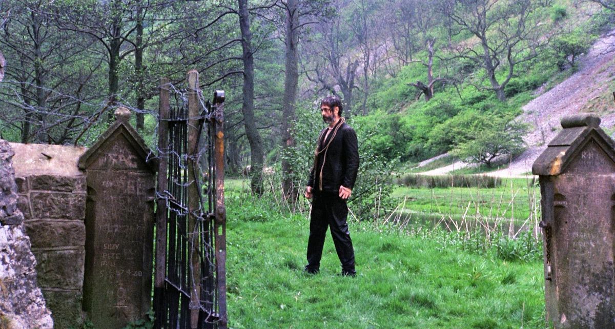 A zombie shambles through a graveyard in The Living Dead at Manchester Morgue.