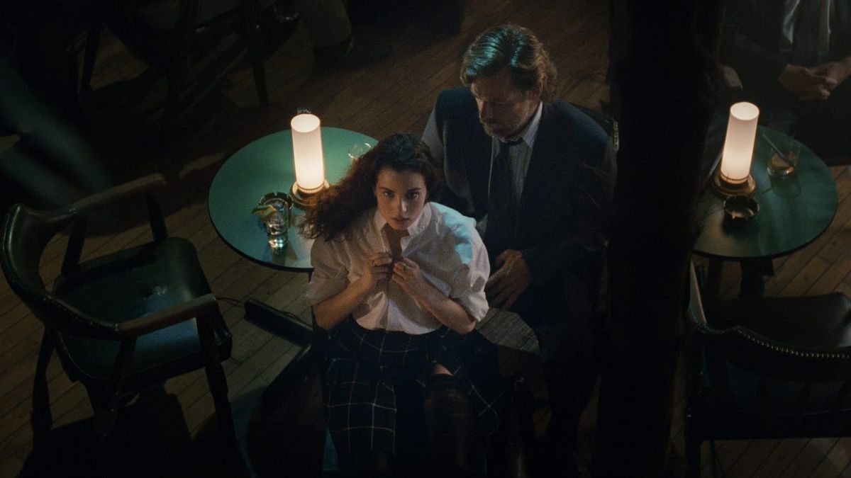 Dressed in a schoolgirl's uniform, Mia Kirshner dances for Bruce Greenwood in a still from Atom Egoyan's EXOTICA.