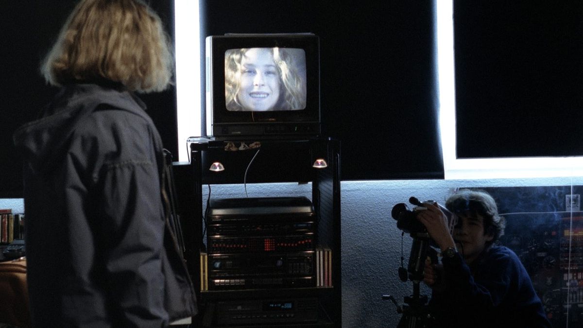 A boy points his camera at a girl in a still from Michael Haneke's BENNY'S VIDEO.