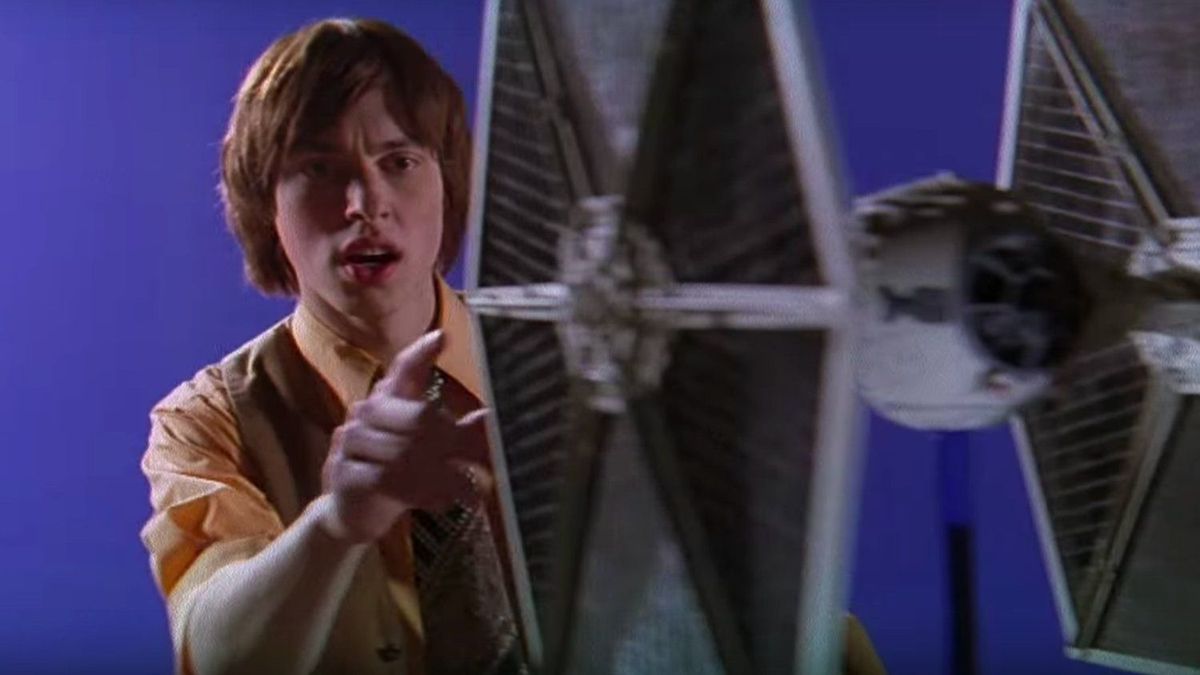 John Francis Daley touches a TIE fighter model in a still from 5-25-77.