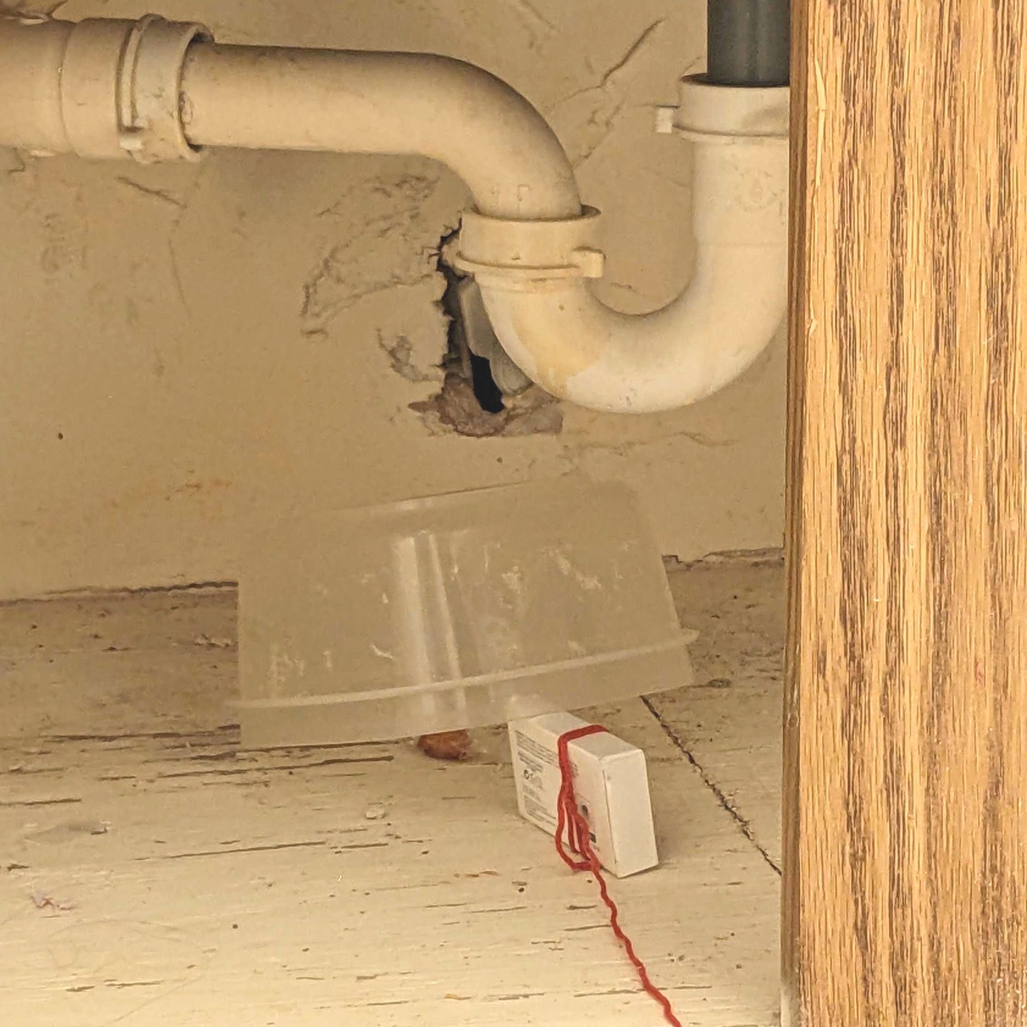 This is an improvised mouse trap involving a tupperware container, a bar of a soap, and a piece of string.