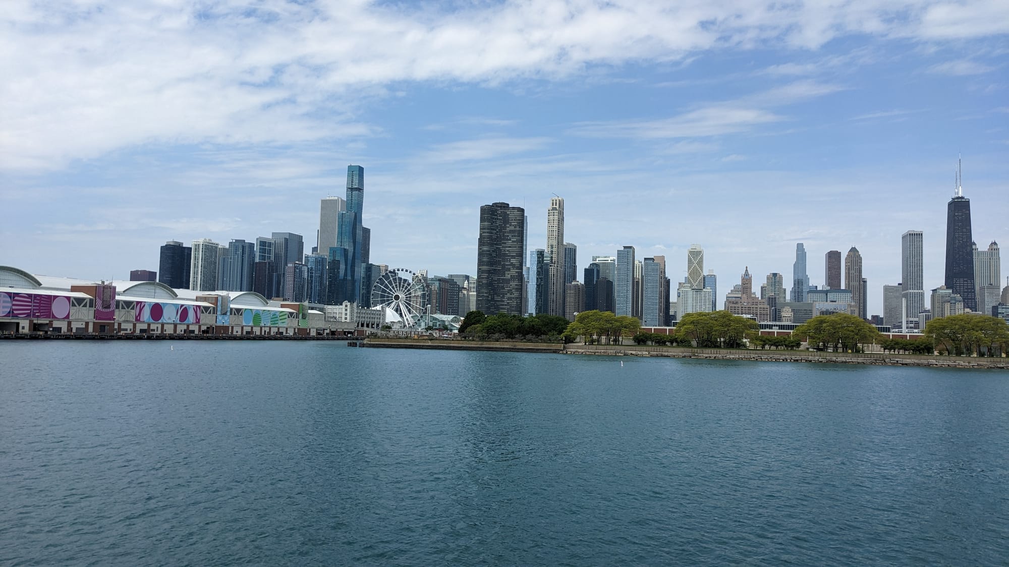 You're looking a view of the Chicago skyline from Lake Michigan with a view of the giant ferris wheel on Navy Pier.
