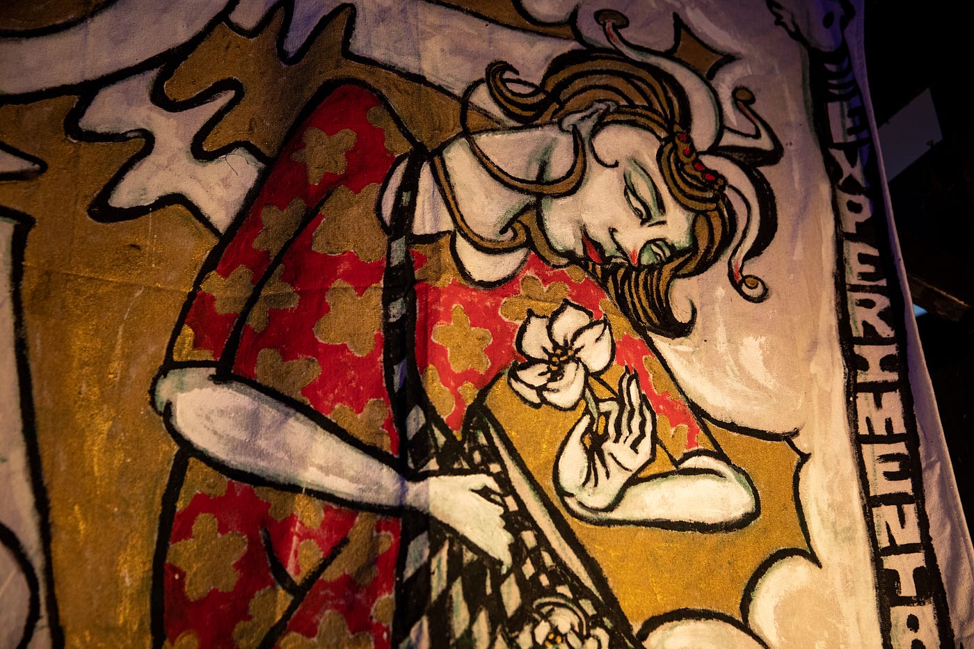 Painted larger than life tarot card portraying a womxn holding a white flower