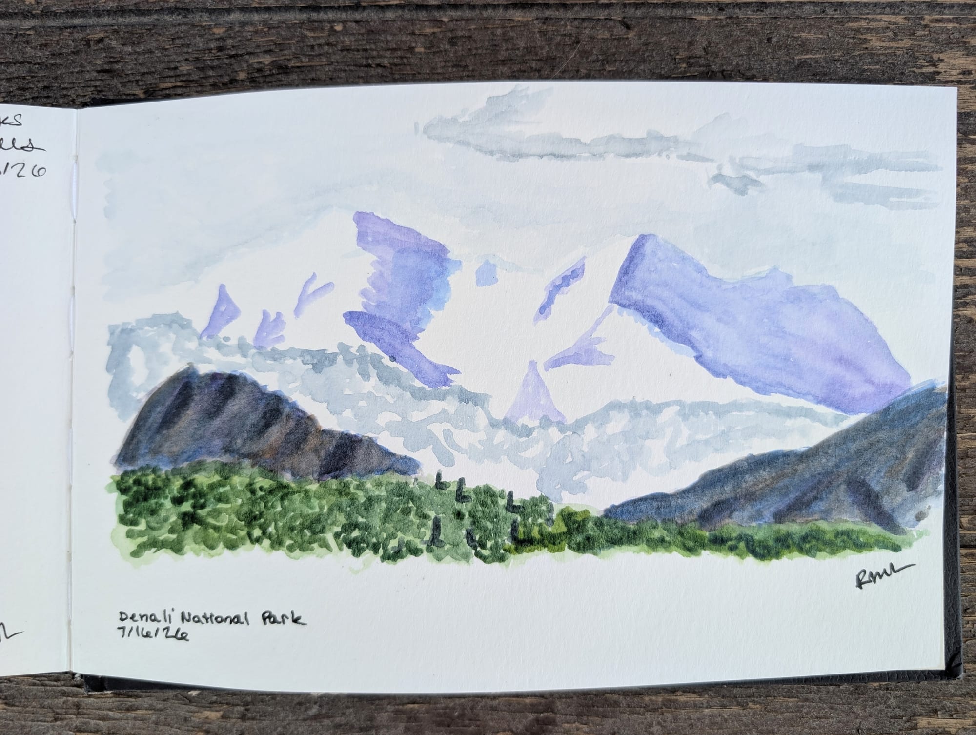 a watercolor in a sketchbook of Mt Denali