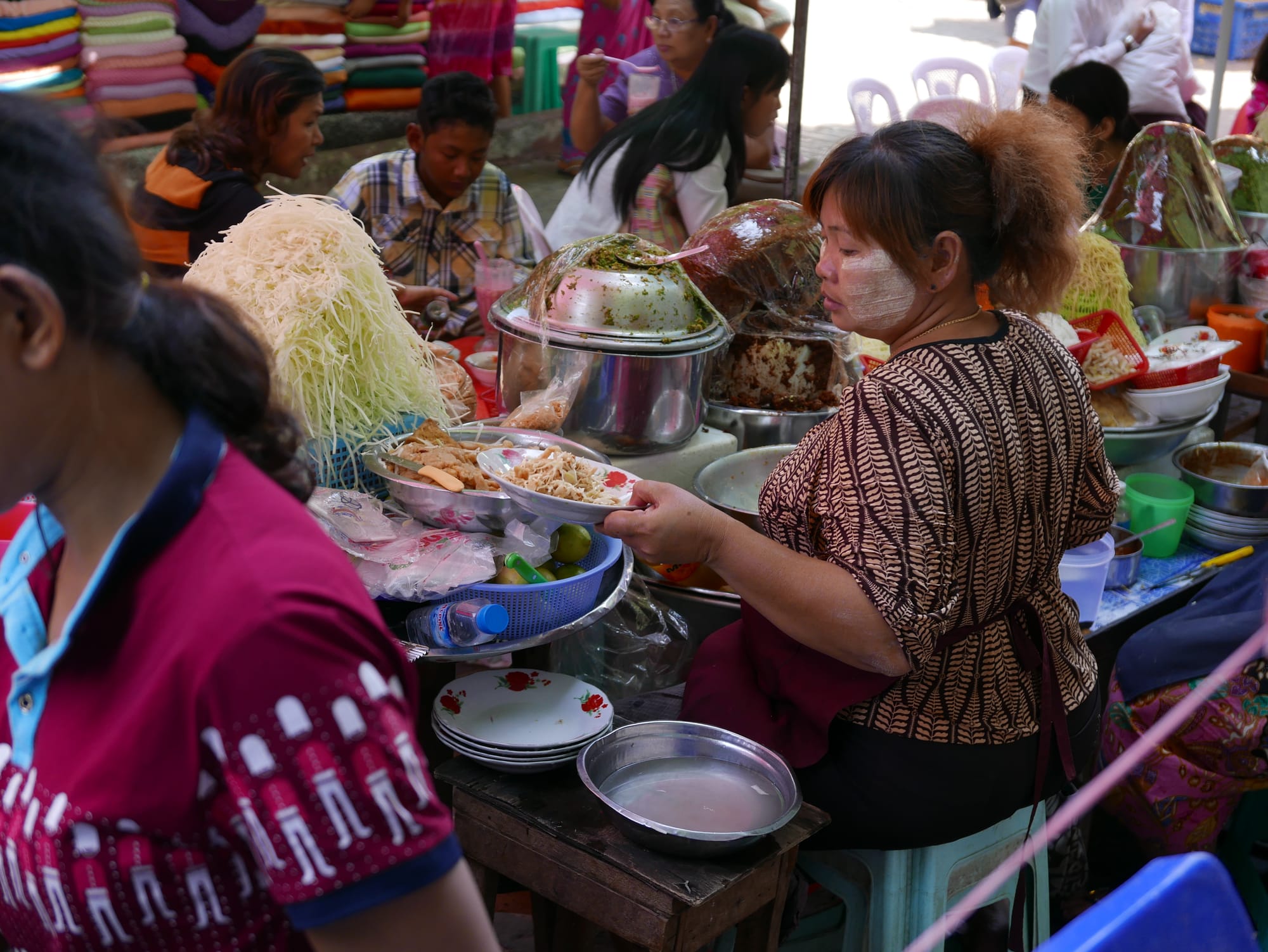Photo by Author — food seller with yellow paste, thanaka — Myanmar (Burma)