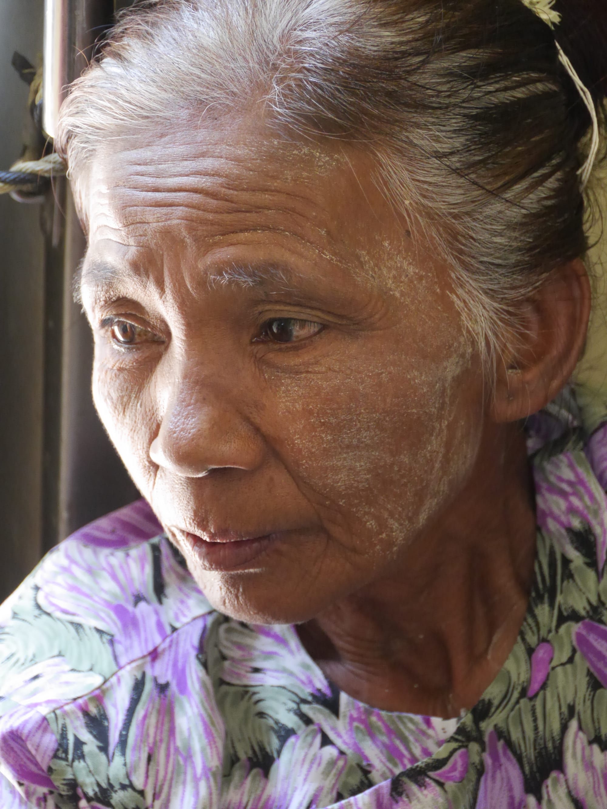 Photo by Author — train passenger with yellow paste, thanaka — Myanmar (Burma)