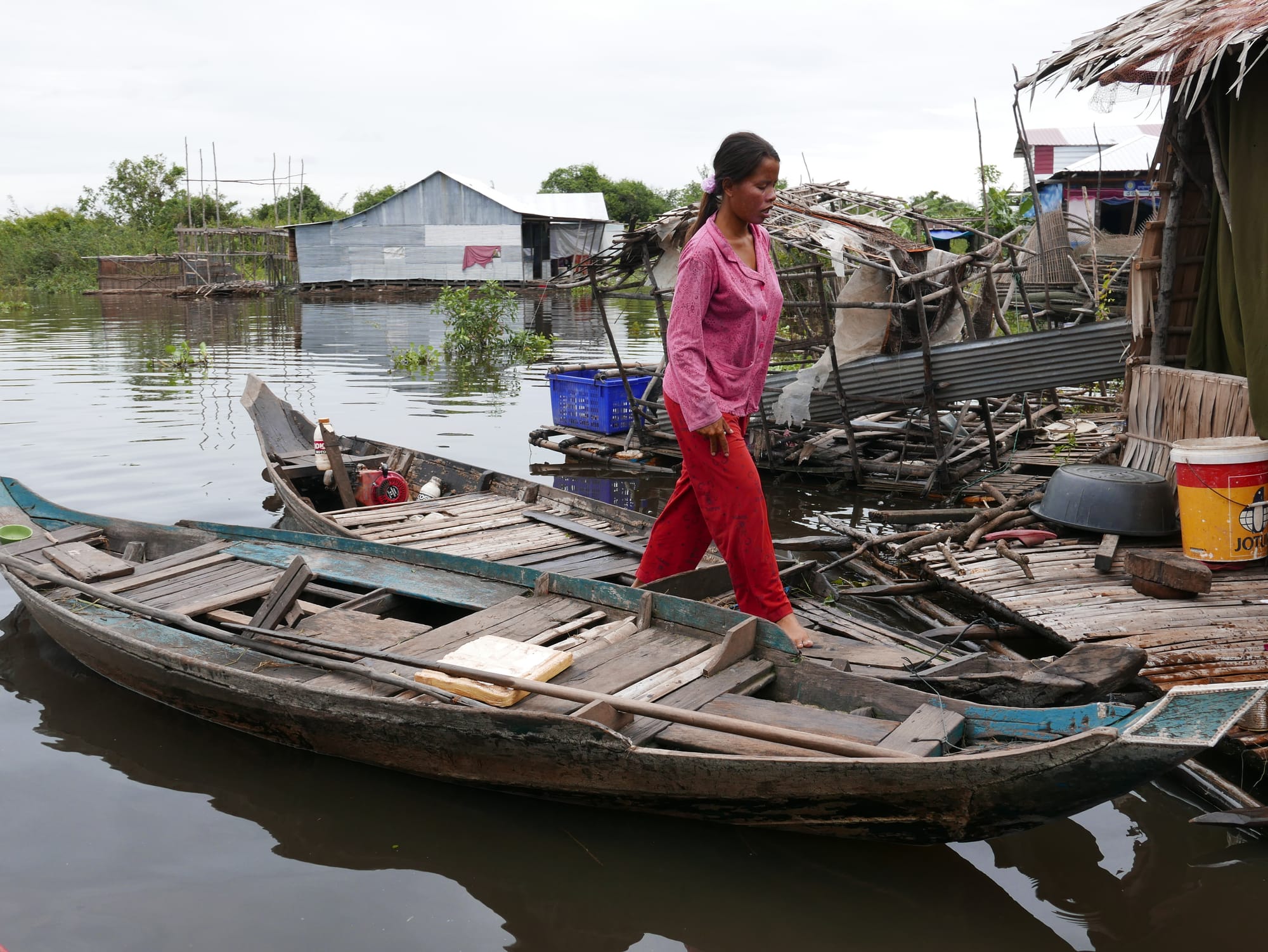 Photo by Author — deftly walking barefoot across the boats — Mechrey Floating Village, Siem Reap, Cambodia