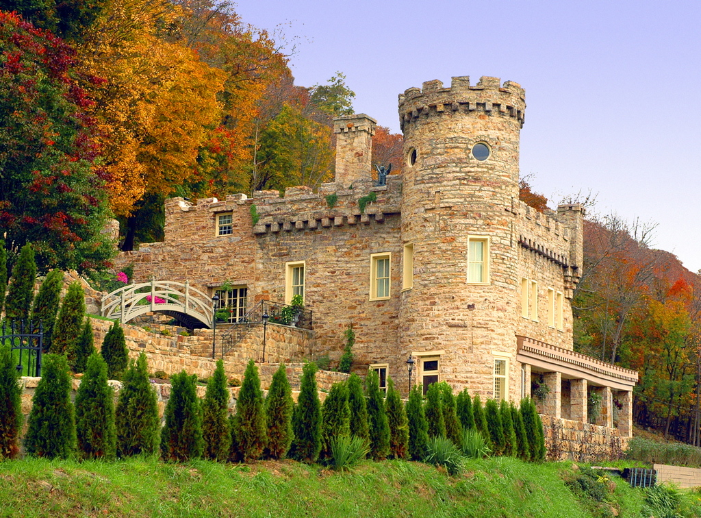 Berkeley Castle, backed by a vibrant display of multi-colored fall leaves, stands elegantly imposing above the Berkeley Springs. Photo: Picryl