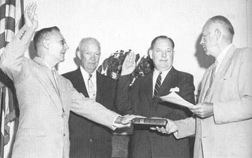 T. Keith Glennan (second from right) and Hugh L. Dryden (left) are sworn in as the first administrator and deputy administrator, respectively, of NASA