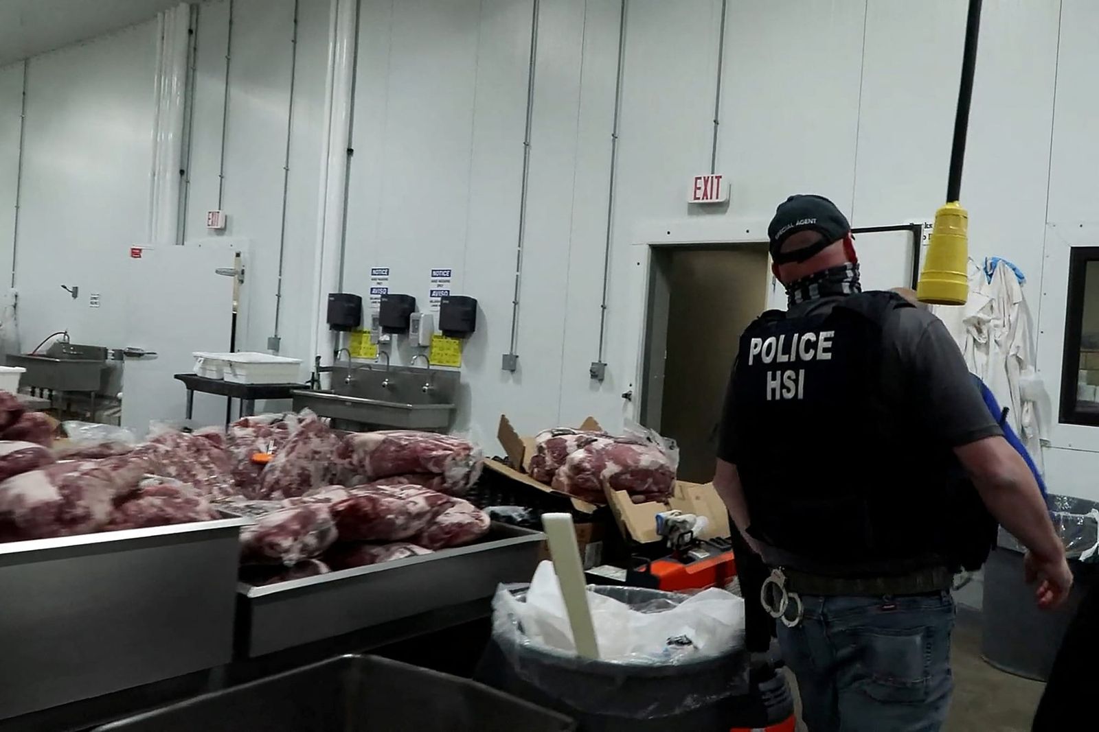 A U.S. Immigration and Customs Enforcement (ICE) agent at a meat-production plant in Omaha, Nebraska | ICE Handout via REUTERS