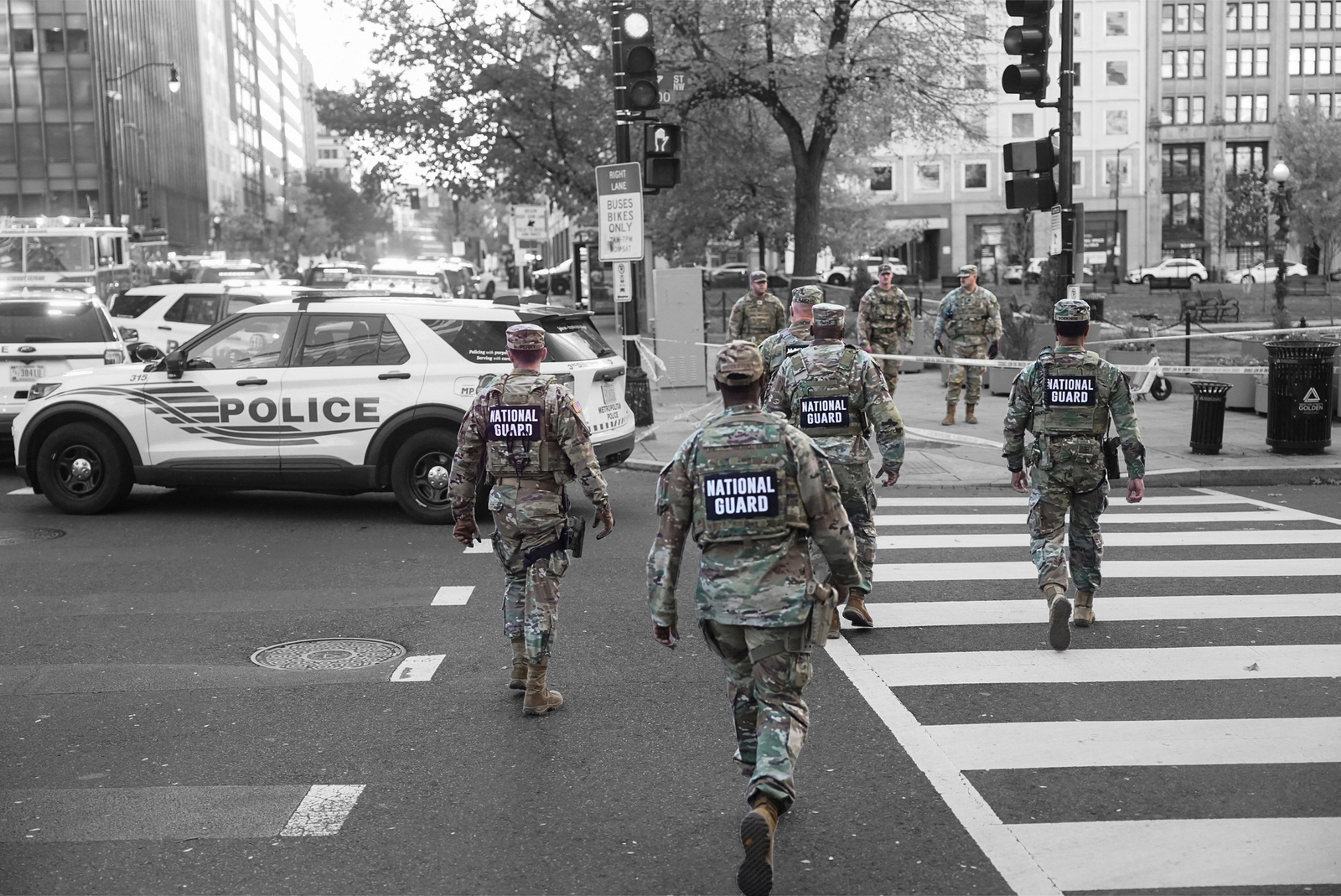 National Guard members walk near a cordoned-off area near the White House on November 26, 2025 | REUTERS/Nathan Howard, edited by Russell Nystrom