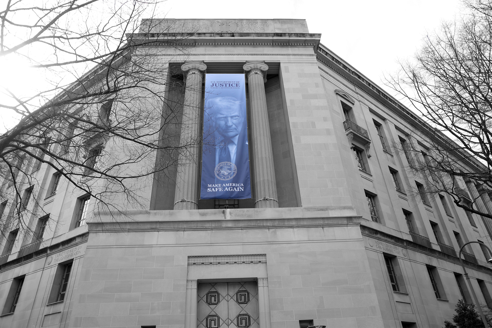 A  banner featuring an image of President Donald Trump is displayed on the facade of the DOJ headquarters | Gent Shkullaku/ZUMA Press Wire, edited by Russell Nystrom