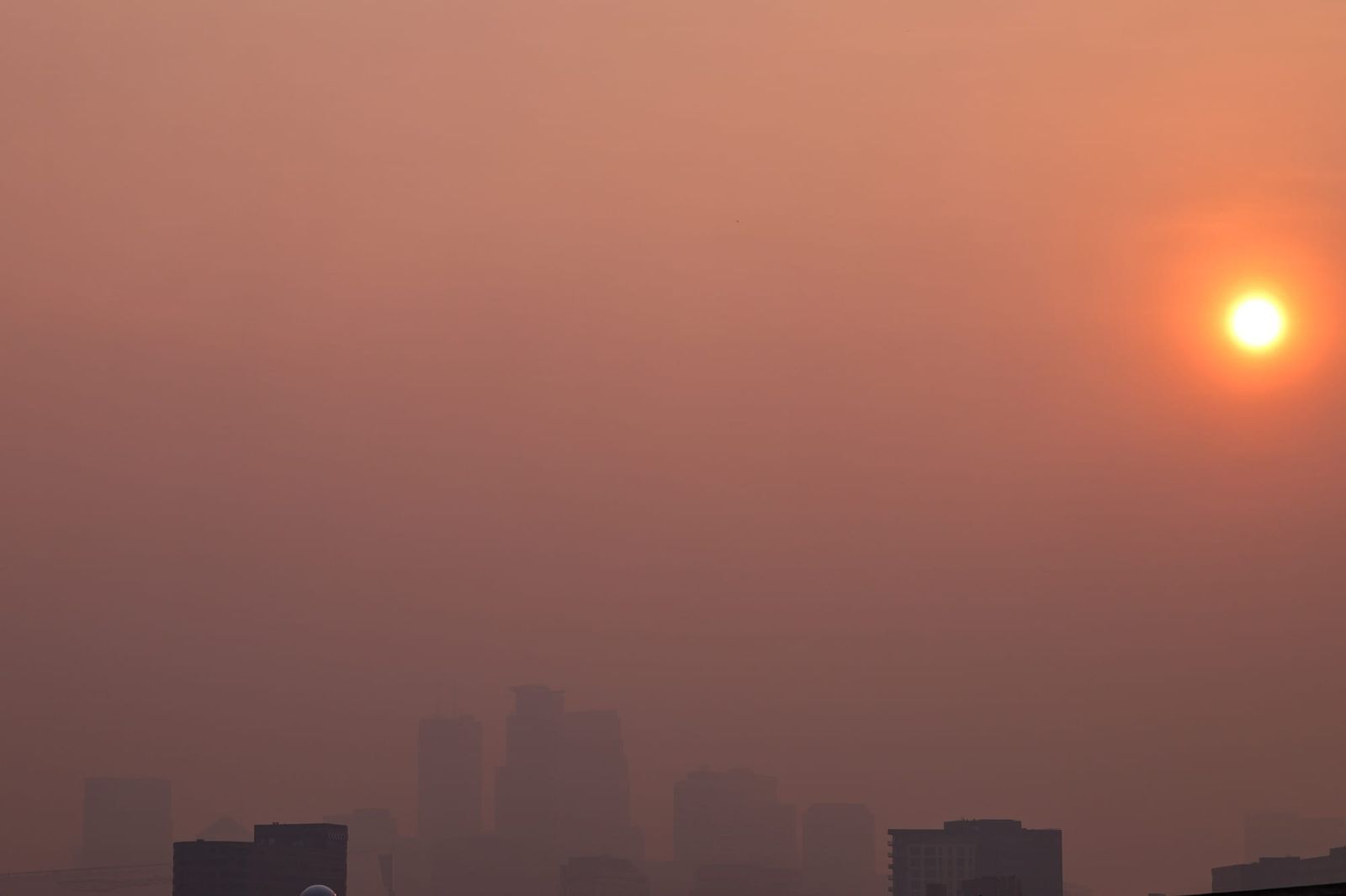 A view of the Minneapolis skyline obscured by wildfire smoke on July 15, 2026