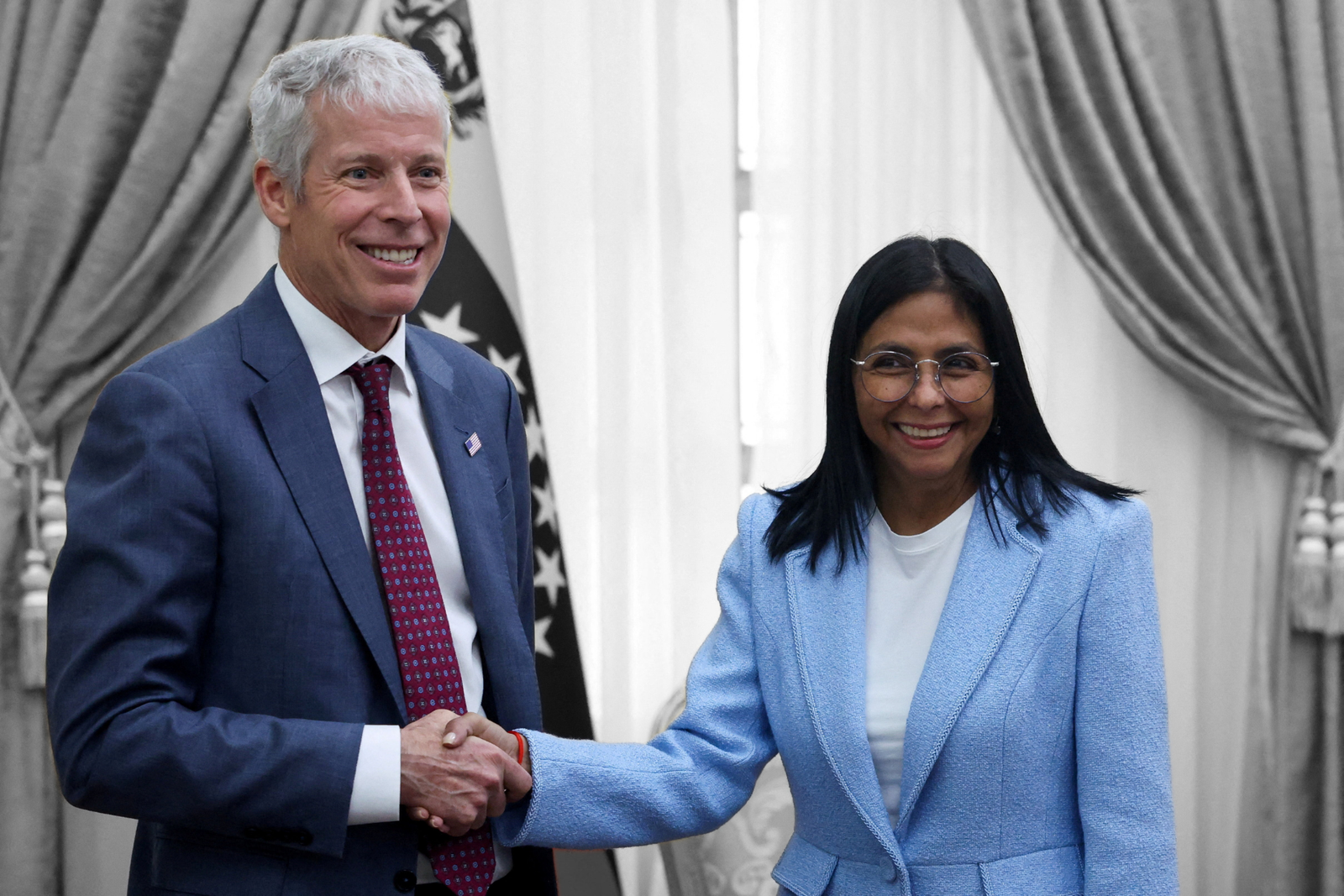 Venezuela's interim President Delcy Rodríguez shakes hands with U.S. Energy Secretary Chris Wright