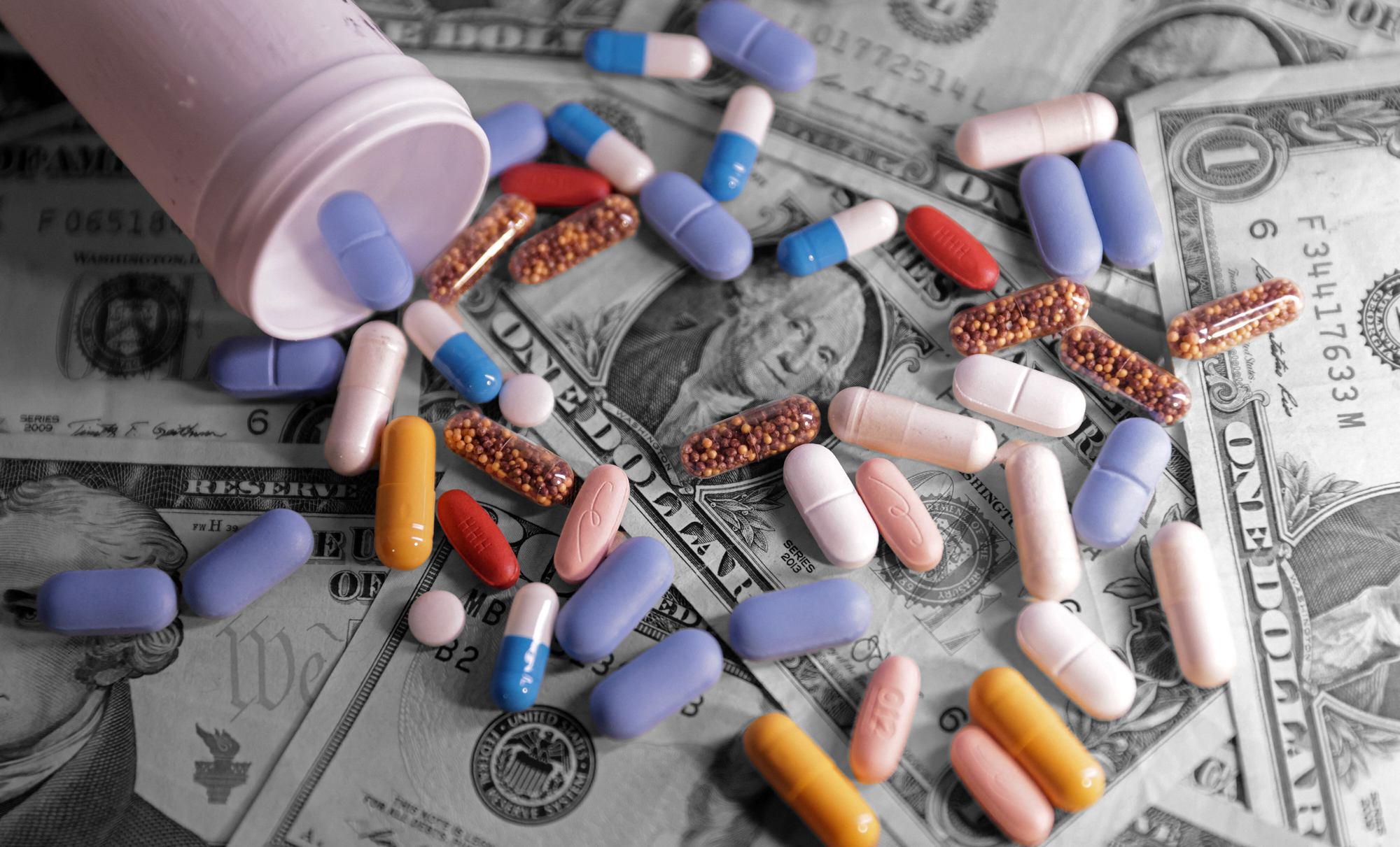 U.S. banknotes and medicines | REUTERS/Dado Ruvic/Illustration, edited by Russell Nystrom