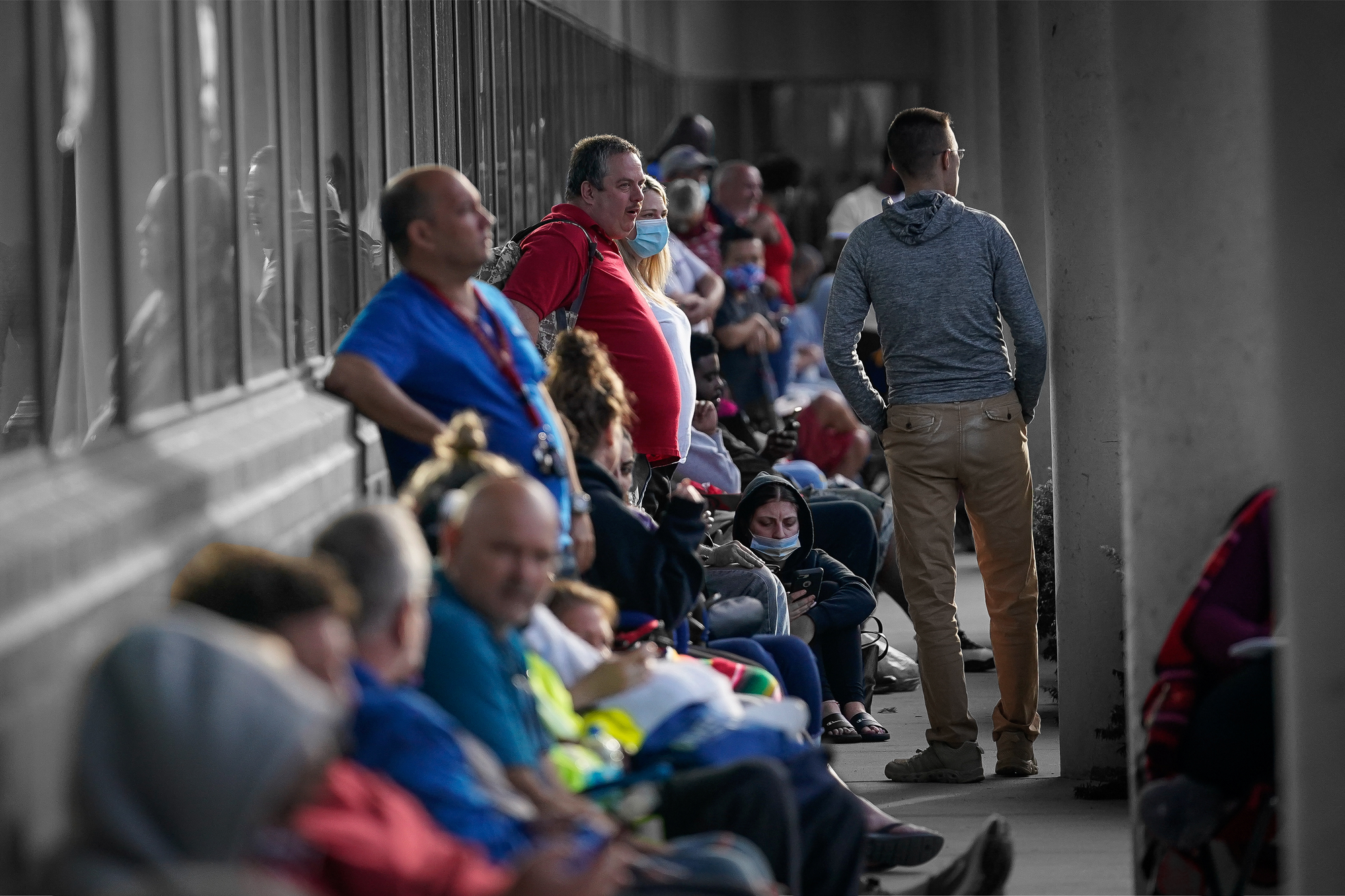 People line up outside a Kentucky Career Center prior to its opening to find assistance with their unemployment claims in Frankfort, Kentucky