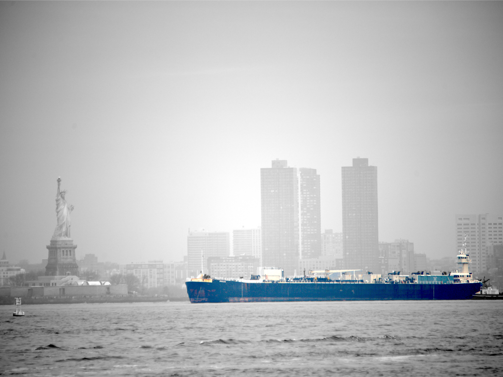 Container ships sail past the Statue of Liberty as they enter the Port of New Jersey.