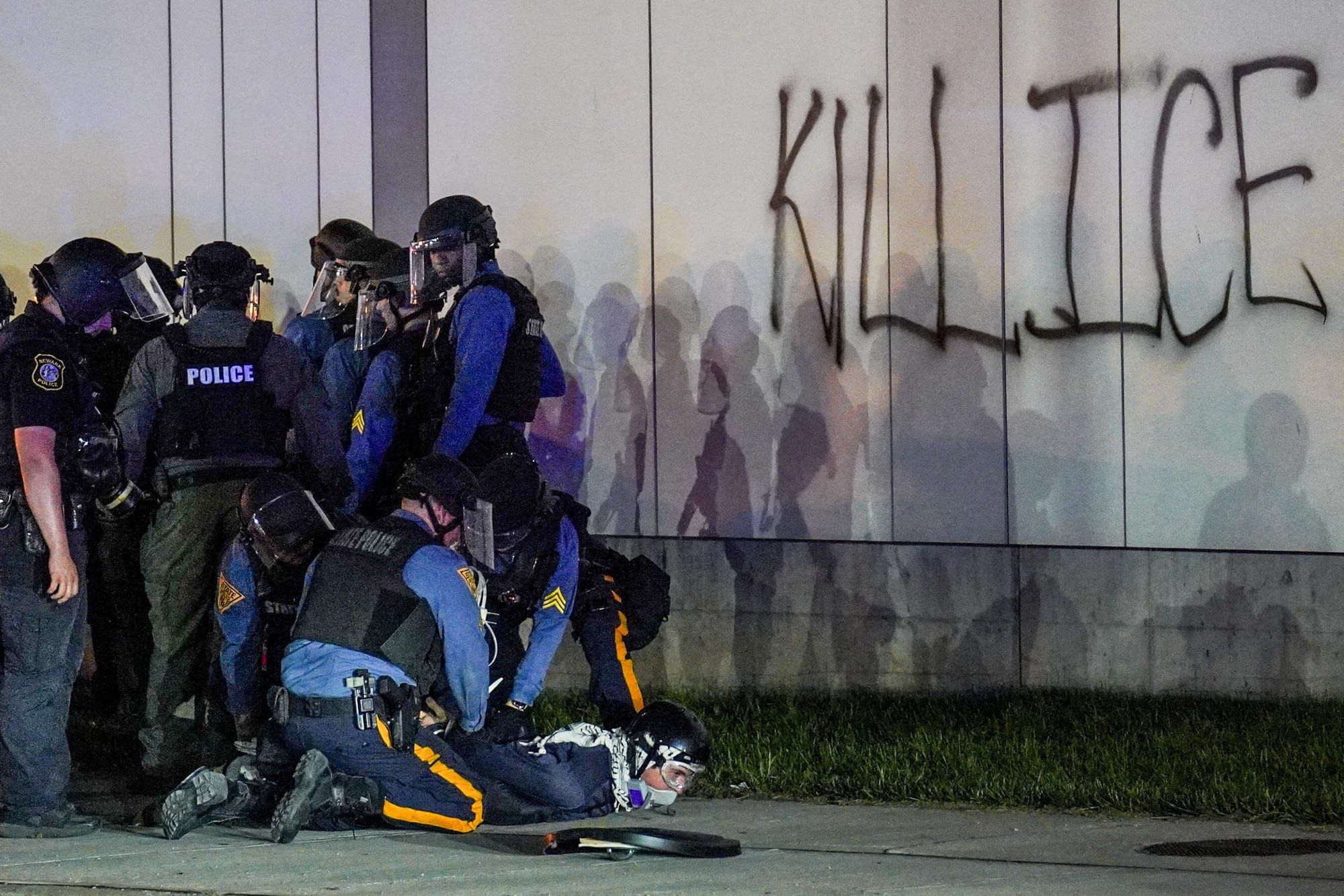 An anti-ICE protester is detained during a curfew outside Delaney Hall in Newark, New Jersey, May 31. REUTERS/Ryan Murphy