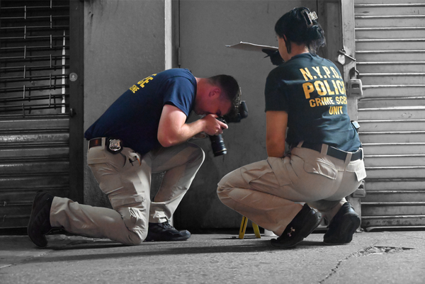 Crime scene investigators with the NYPD work at the scene of a fatal shooting in Brooklyn in August 2025 | Photo by Kyle Mazza/NurPhoto, edited by Russell Nystrom