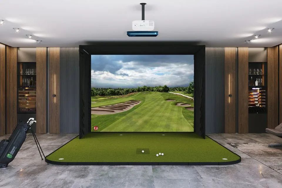 Home golf simulator setup with hitting mat, impact screen and projector