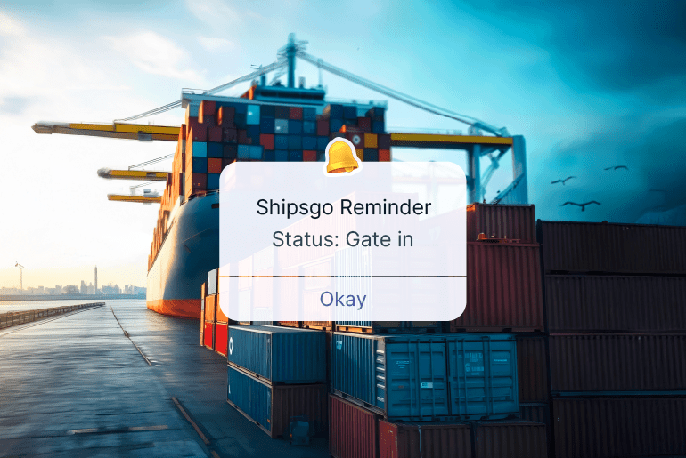 Container Gate-In status notification displayed in front of a container ship and stacked shipping containers at a port terminal.